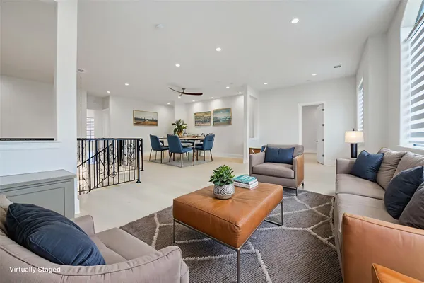 a living room with furniture and a view of kitchen