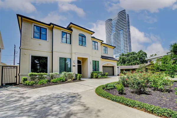 a front view of a house with a yard and potted plants
