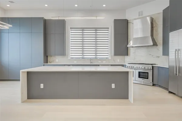 a large white kitchen with a large window