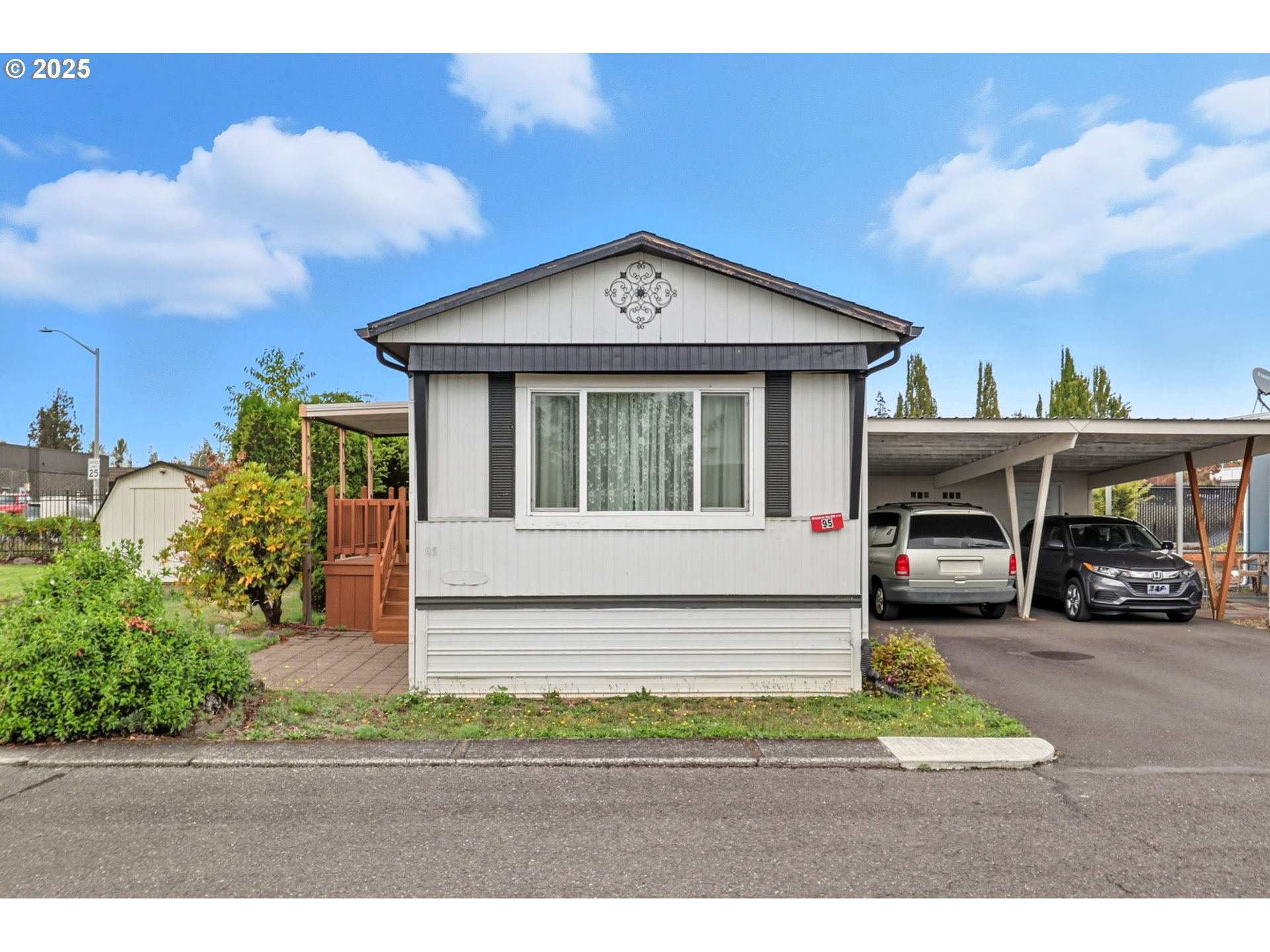 a front view of a house with a garden and plants