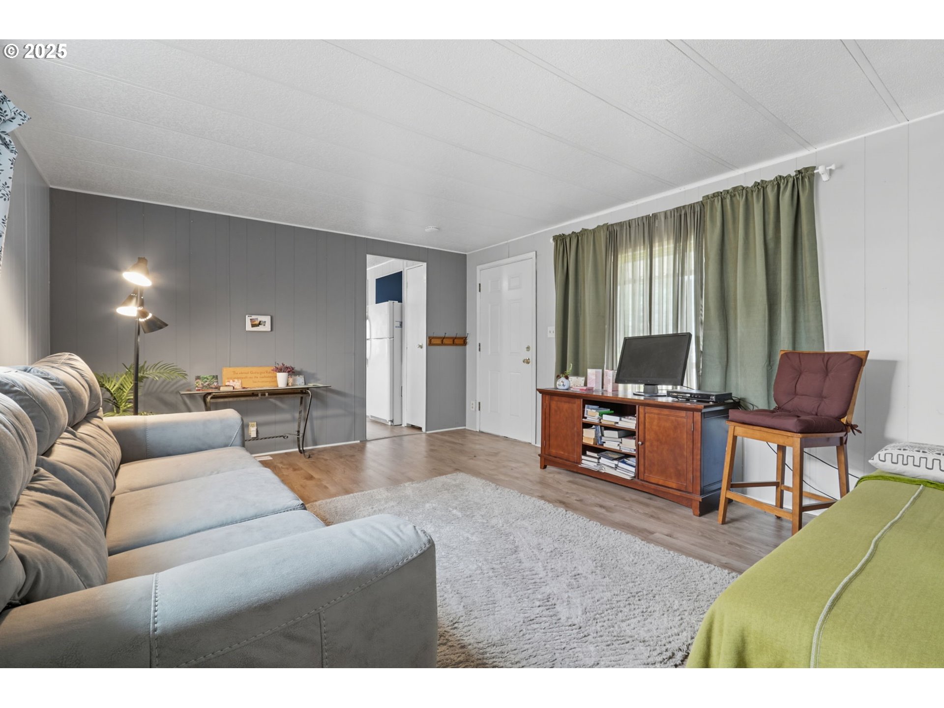 300 Southwest 7th Avenue, Unit 95 Battle Ground, WA 98604 - Photo 4 of 27 a living room with furniture and a flat screen tv