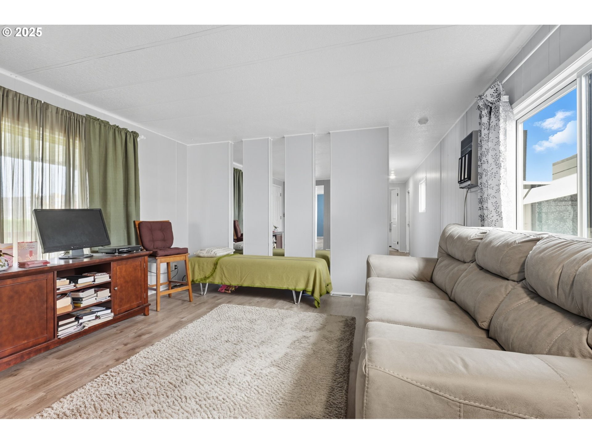 300 Southwest 7th Avenue, Unit 95 Battle Ground, WA 98604 - Photo 5 of 27 a living room with furniture and a flat screen tv