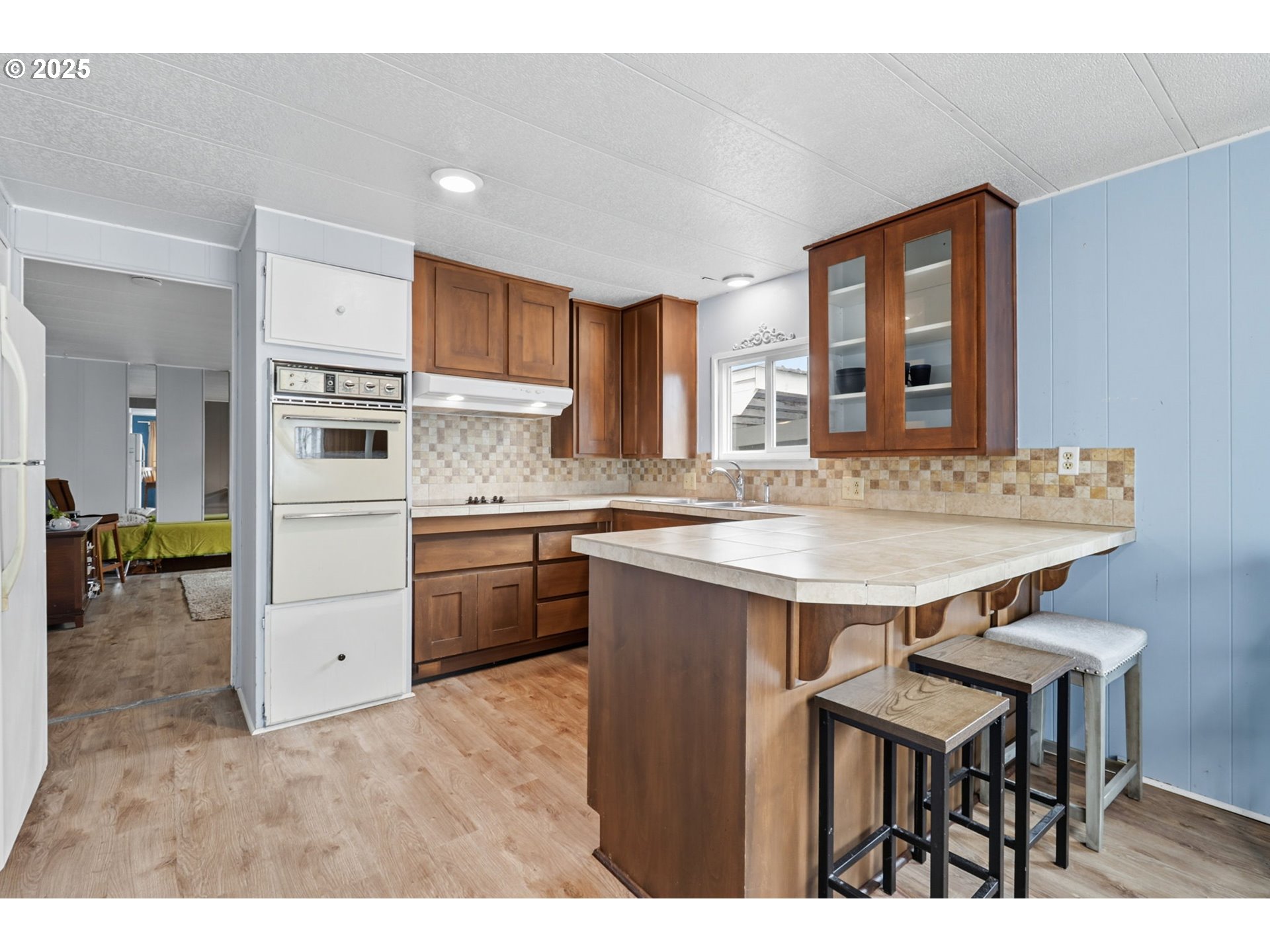 300 Southwest 7th Avenue, Unit 95 Battle Ground, WA 98604 - Photo 9 of 27 a kitchen with a table chairs refrigerator and cabinets