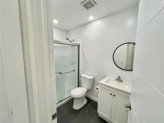 a bathroom with a toilet sink and a mirror
