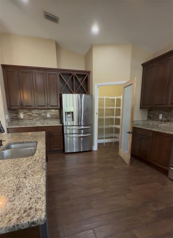 765 Sloans Ridge Road Groveland, FL 34736 - Photo 14 of 62 a kitchen with granite countertop a refrigerator and a sink