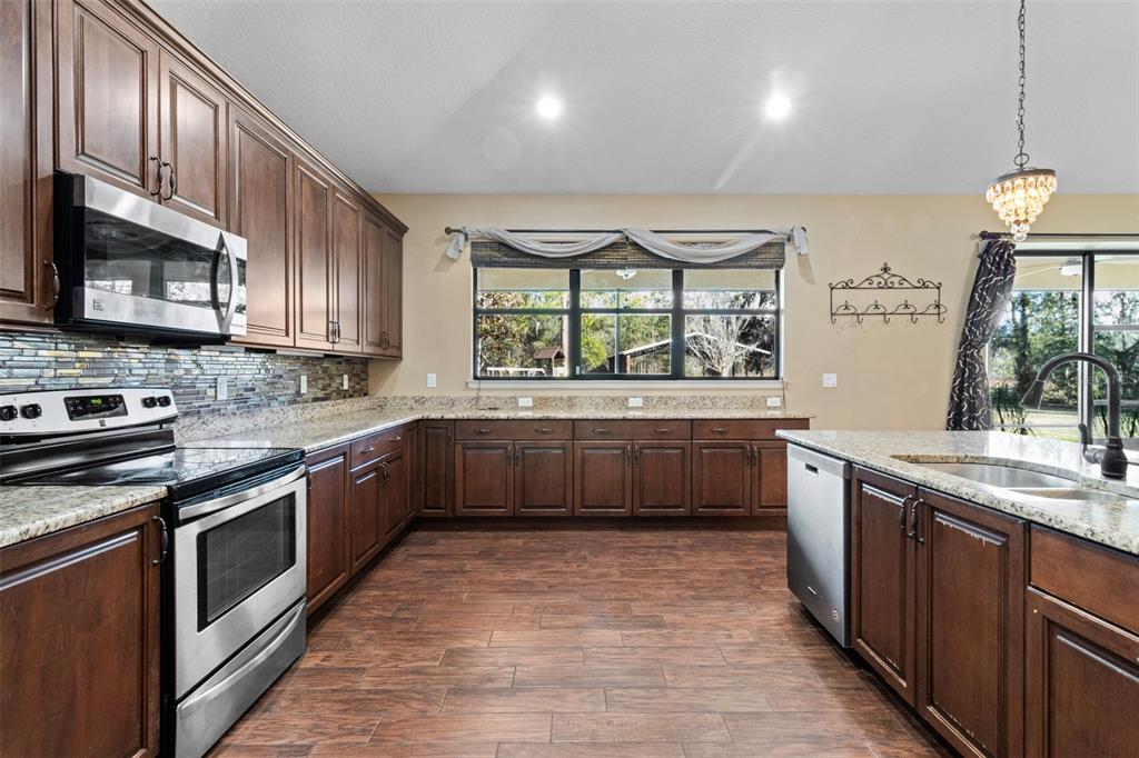 765 Sloans Ridge Road Groveland, FL 34736 - Photo 17 of 62 a kitchen with stainless steel appliances a sink and a stove