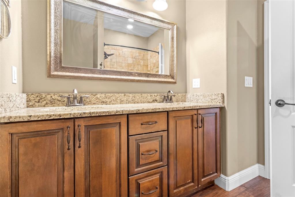 765 Sloans Ridge Road Groveland, FL 34736 - Photo 33 of 62 a bathroom with a granite countertop sink and a mirror
