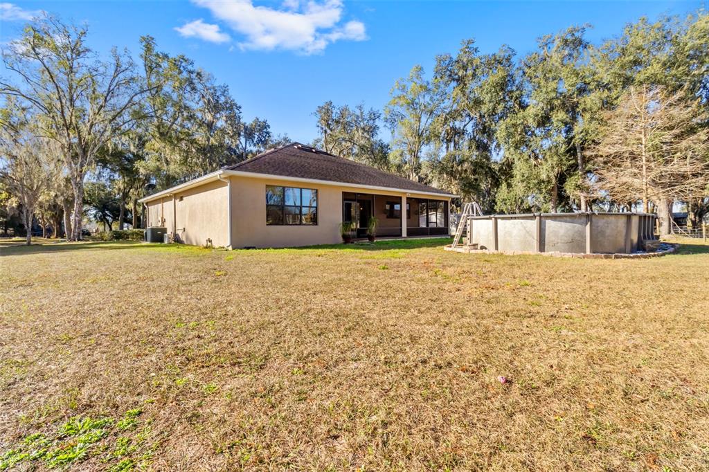 765 Sloans Ridge Road Groveland, FL 34736 - Photo 38 of 62 a view of a house with a yard