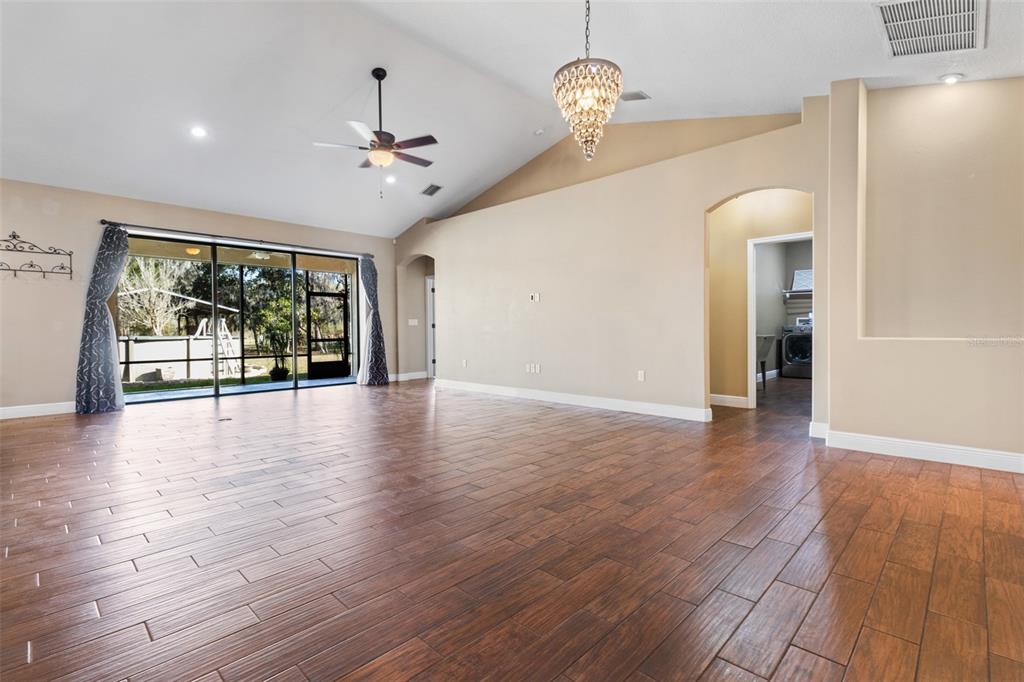 765 Sloans Ridge Road Groveland, FL 34736 - Photo 8 of 62 a view of an empty room with wooden floor and a window