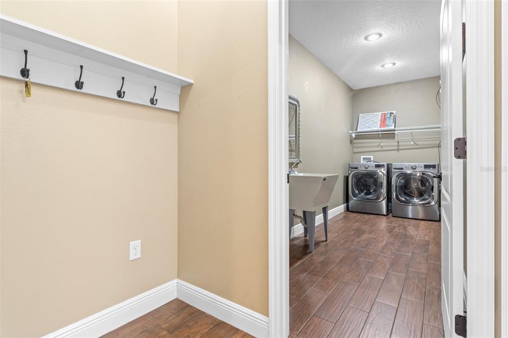 765 Sloans Ridge Road Groveland, FL 34736 - Photo 9 of 62 a view of a hallway with wooden floor and a bathroom
