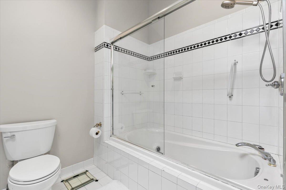 37 Talcott Road Rye Brook, NY 10573 - Photo 12 of 25 Bathtub and shower combination featuring a glass sliding door