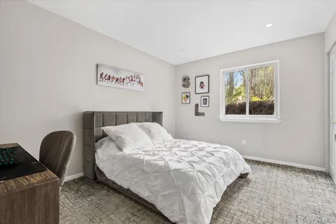 a bedroom with a bed and a chair