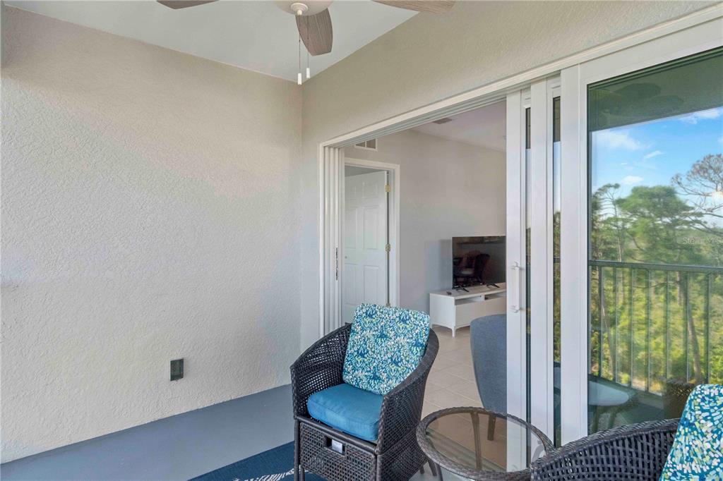 8409 Placida Road, Unit 405 Placida, FL 33946 - Photo 16 of 77 a living room with furniture and a floor to ceiling window