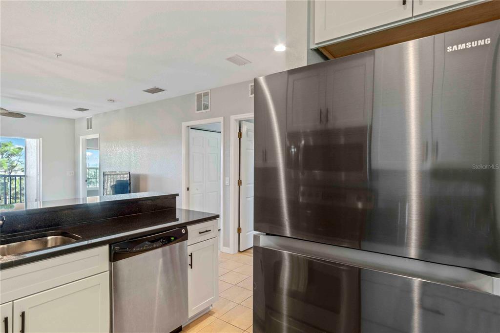 8409 Placida Road, Unit 405 Placida, FL 33946 - Photo 27 of 77 a kitchen with stainless steel appliances a refrigerator and a sink