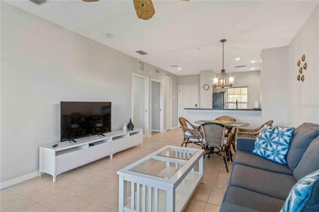 8409 Placida Road, Unit 405 Placida, FL 33946 - Photo 33 of 77 a living room with furniture and a flat screen tv