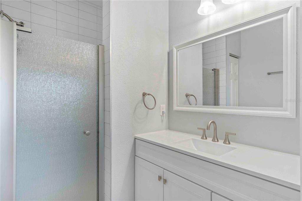 8409 Placida Road, Unit 405 Placida, FL 33946 - Photo 39 of 77 a bathroom with a granite countertop sink and a mirror