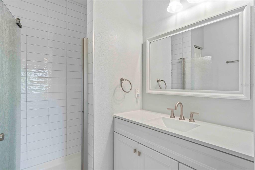 8409 Placida Road, Unit 405 Placida, FL 33946 - Photo 40 of 77 a bathroom with a sink and a mirror