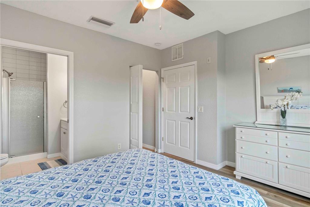 8409 Placida Road, Unit 405 Placida, FL 33946 - Photo 44 of 77 a bedroom with a bed and a dresser