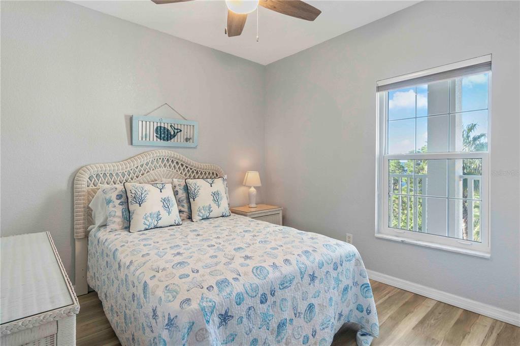 8409 Placida Road, Unit 405 Placida, FL 33946 - Photo 46 of 77 a bedroom with a bed and a window