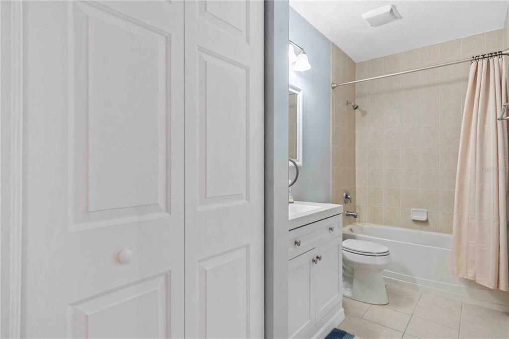 8409 Placida Road, Unit 405 Placida, FL 33946 - Photo 48 of 77 a bathroom with a granite countertop toilet a sink and a mirror