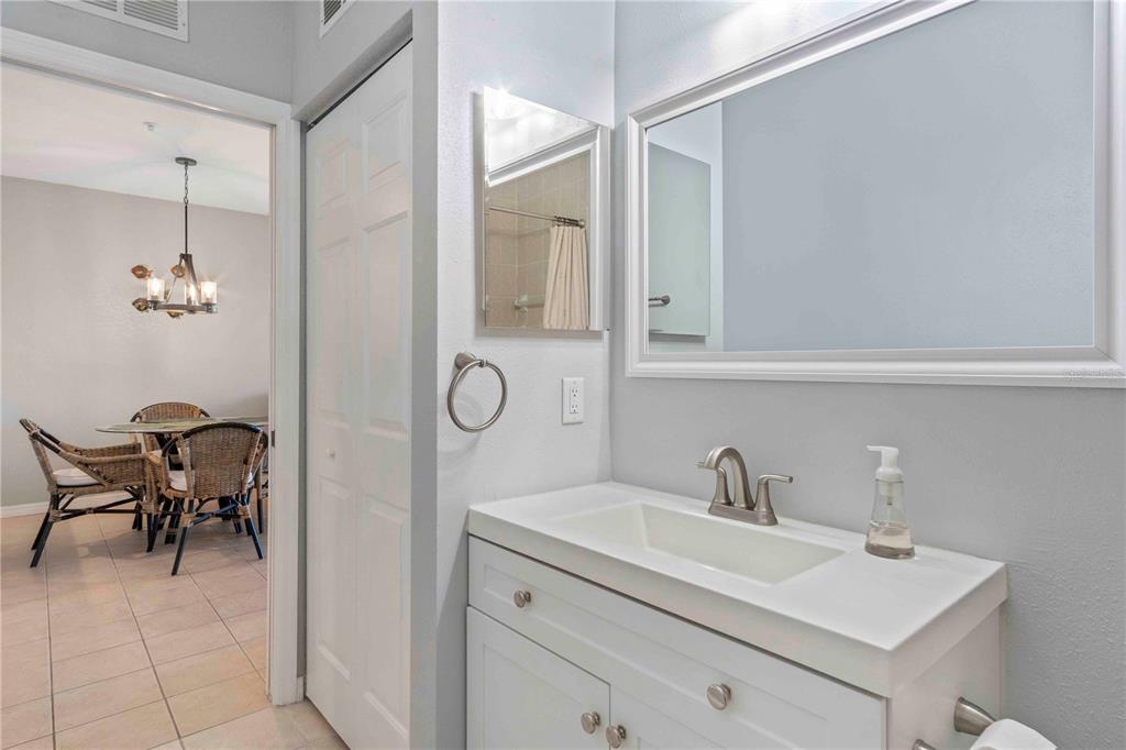 8409 Placida Road, Unit 405 Placida, FL 33946 - Photo 51 of 77 a spacious bathroom with a sink a mirror and a shower