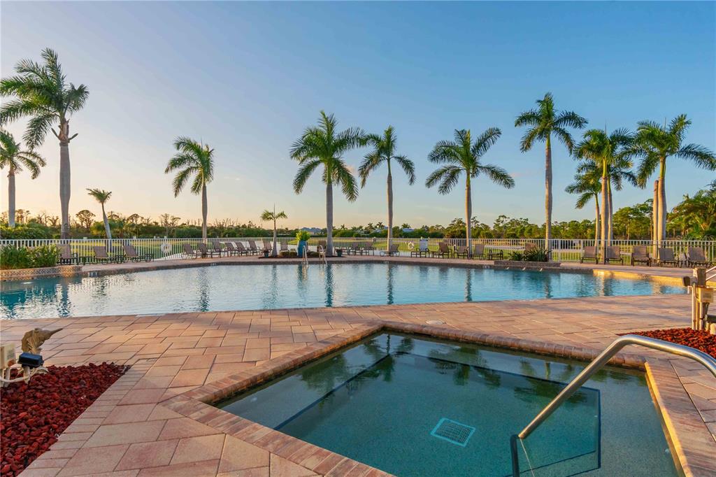 8409 Placida Road, Unit 405 Placida, FL 33946 - Photo 57 of 77 a view of swimming pool with a table and chairs