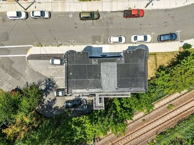 a front view of a house with plants