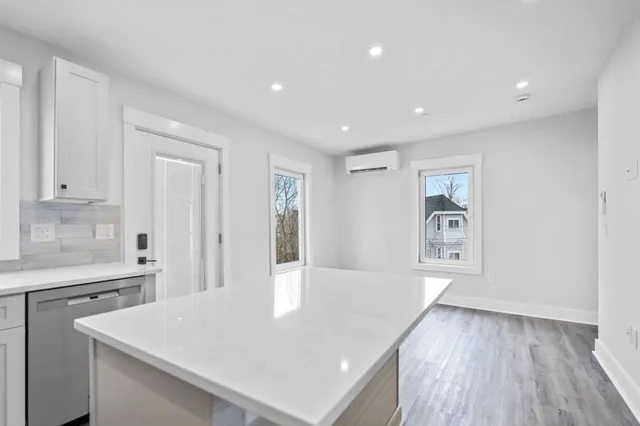 a view of kitchen with furniture and wooden floor