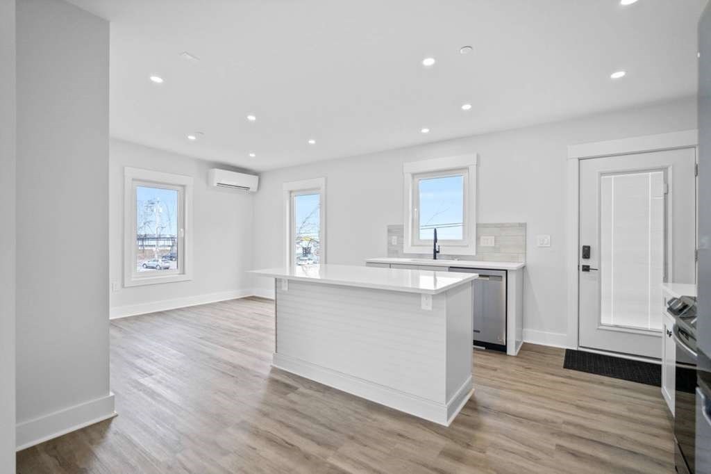 6 Garfield Avenue Revere, MA 02151 - Photo 22 of 29 a large kitchen with cabinets and wooden floor