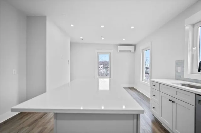 a kitchen with a sink stainless steel appliances and cabinets