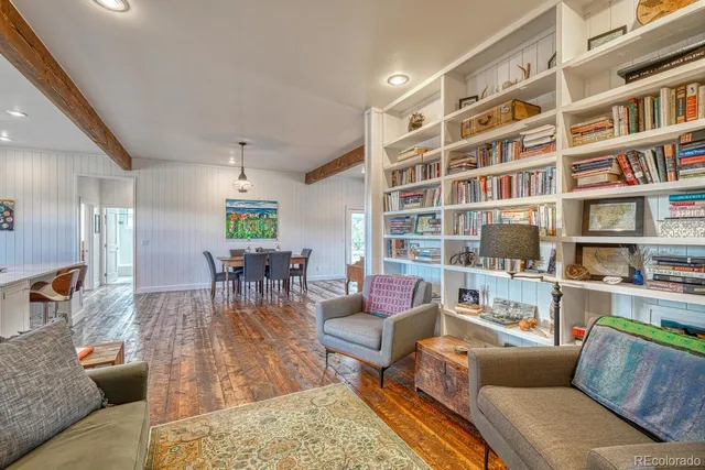 a living room with furniture and a book shelf