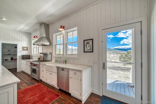 a kitchen with a stove a sink and a refrigerator