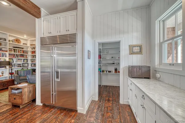 a kitchen with a refrigerator and a sink