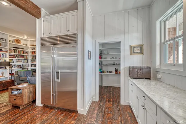 a kitchen with a refrigerator and a sink