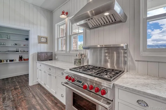 a kitchen with a stove and a wooden cabinets