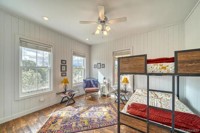 a living room with furniture a window and flat screen tv