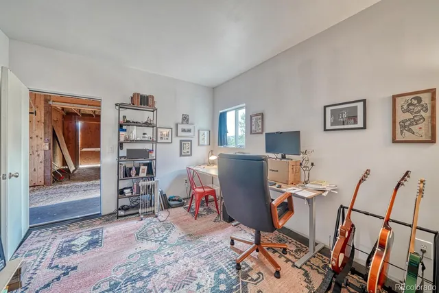 a view of a workspace with furniture and wooden floor