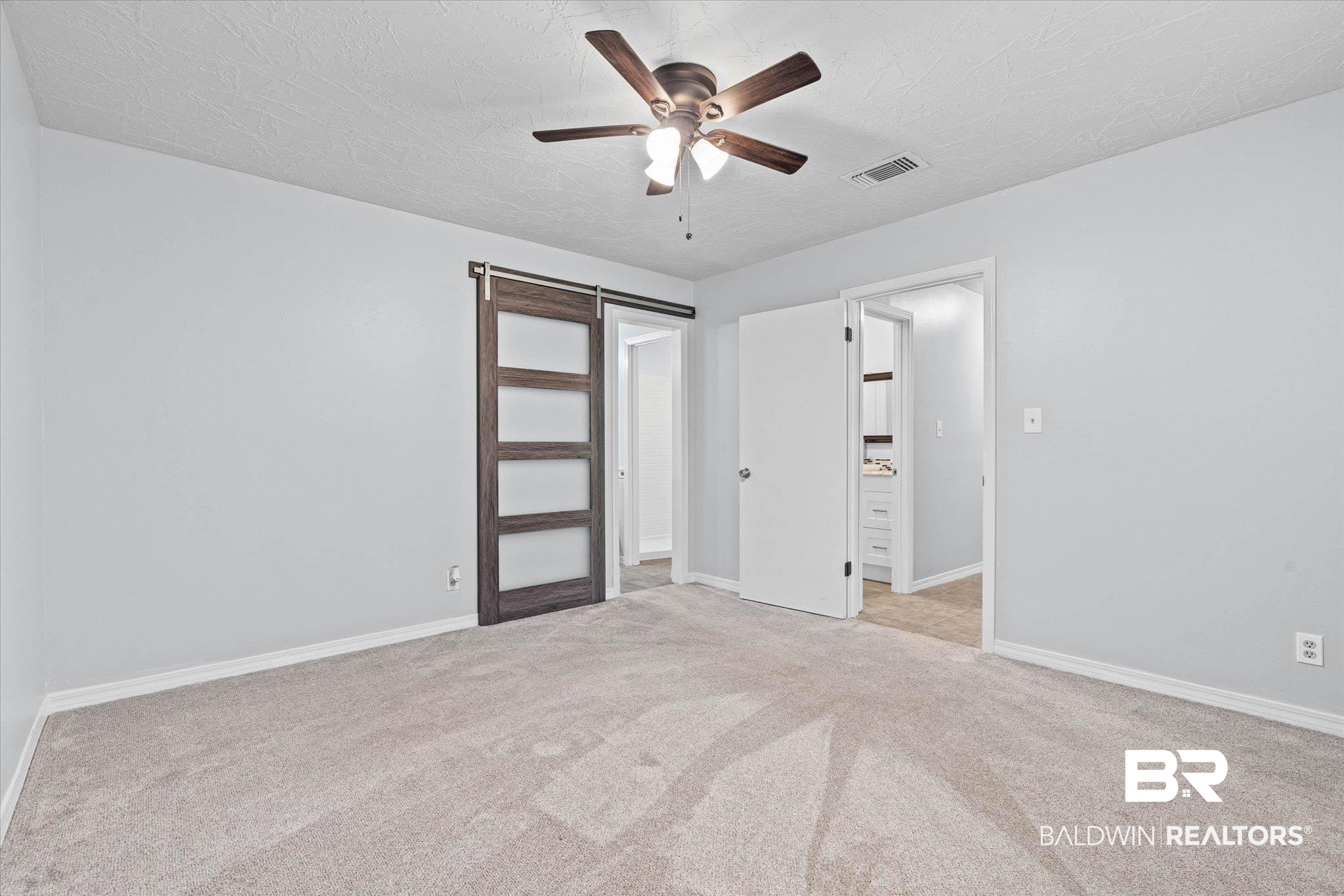 500 Grant Street, Unit C210 Daphne, AL 36526 - Photo 16 of 26 Carpeted room featuring a ceiling fan with integrated lighting, light gray wall paint, and white baseboards