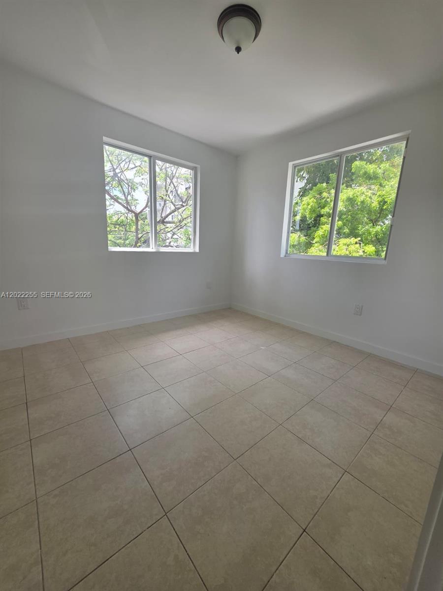 829 Southwest 3rd Street, Unit 831 Miami, FL 33130 - Photo 2 of 21 an empty room with windows