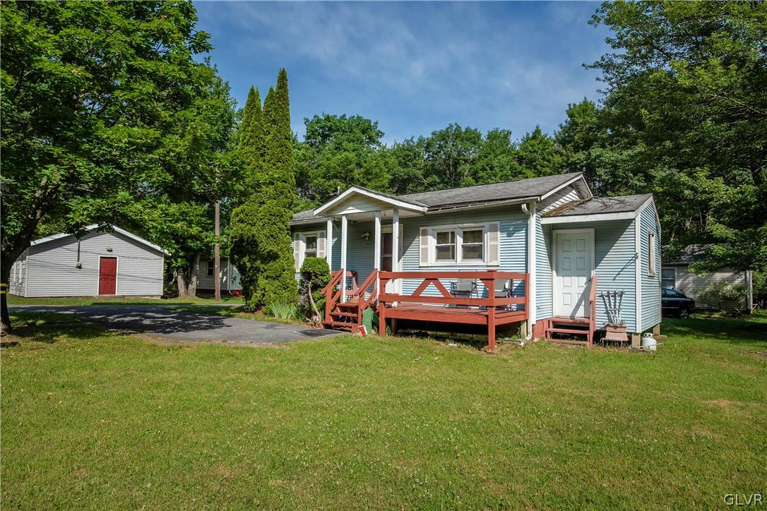 2995 Long Pond Road Pocono Summit, PA 18346 - Photo 29 of 40 a front view of a house with a garden and trees