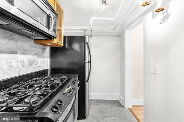 a kitchen with a stove and a refrigerator