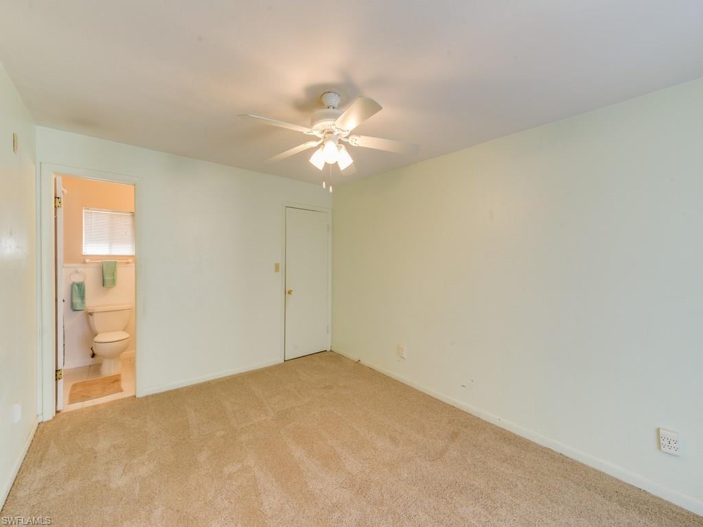449 Castle Road Naples, FL 34119 - Photo 8 of 11 Master Bedroom/Bath. New Carpet throughout.