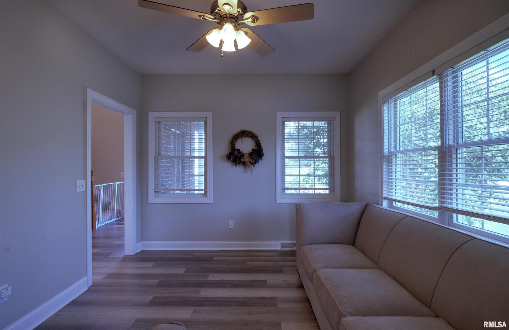 1917 11th Street Camanche, IA 52730 - Photo 12 of 40 a living room with furniture and a window