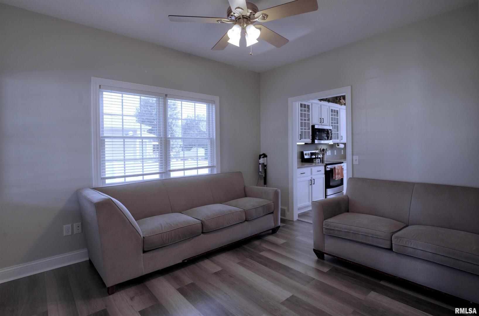 1917 11th Street Camanche, IA 52730 - Photo 13 of 40 a living room with furniture and a chandelier