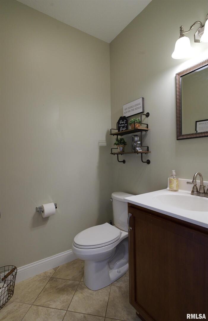 1917 11th Street Camanche, IA 52730 - Photo 14 of 40 a bathroom with a toilet a sink and mirror
