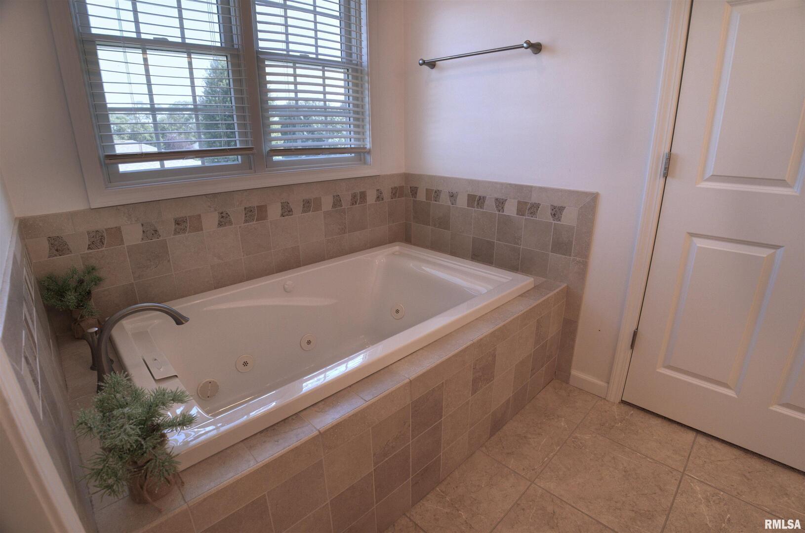 1917 11th Street Camanche, IA 52730 - Photo 16 of 40 a bathroom with a tub and a window