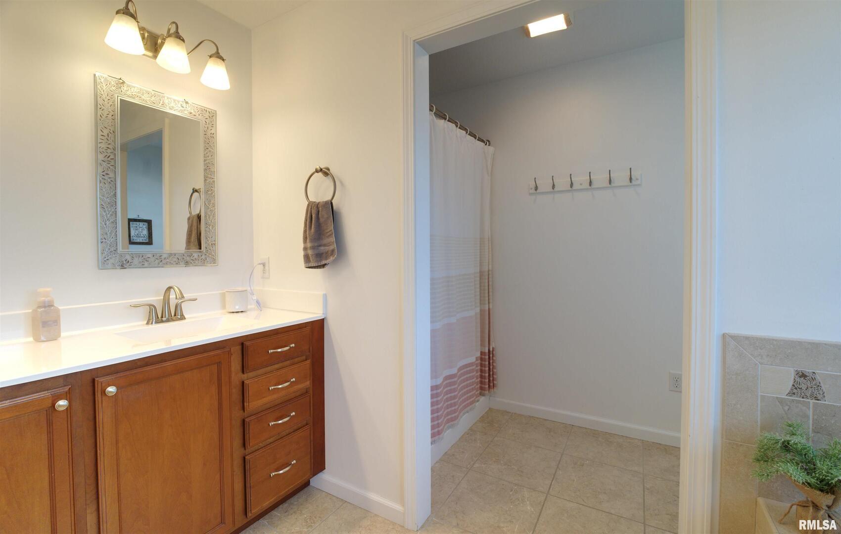 1917 11th Street Camanche, IA 52730 - Photo 18 of 40 a bathroom with a double vanity sink and mirror