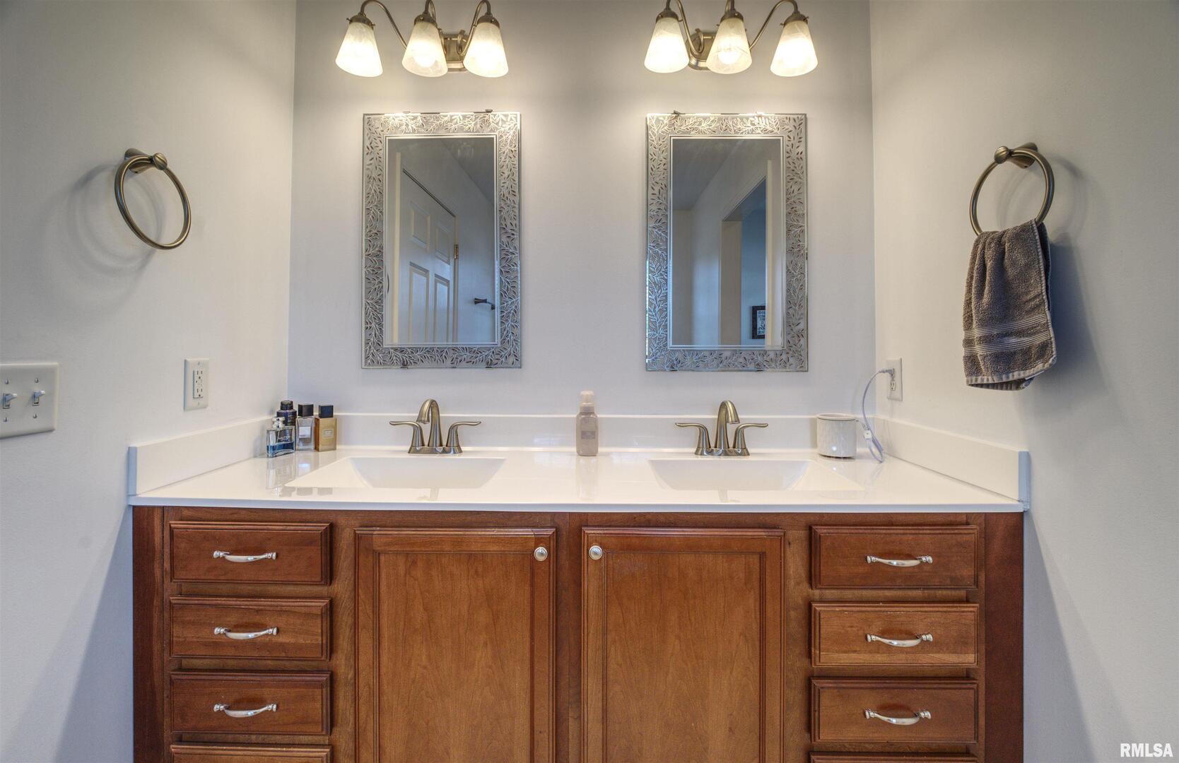 1917 11th Street Camanche, IA 52730 - Photo 19 of 40 a bathroom with a double vanity sink and a mirror