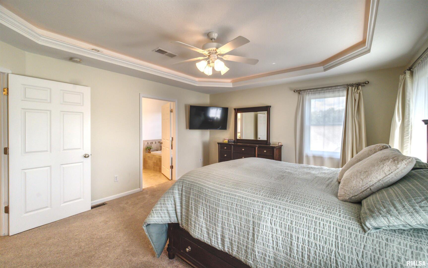 1917 11th Street Camanche, IA 52730 - Photo 20 of 40 a bedroom with a large bed and a chandelier