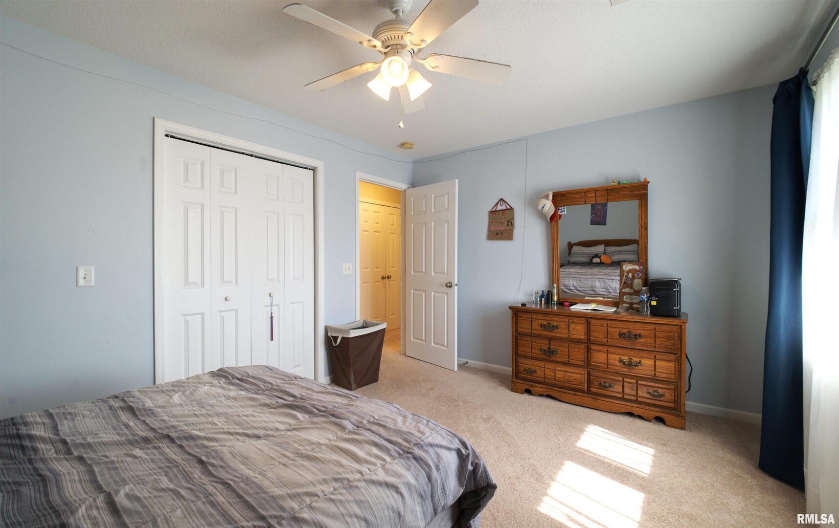 1917 11th Street Camanche, IA 52730 - Photo 24 of 40 a bedroom with a bed and a chandelier